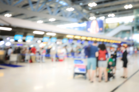 Blurred image of airport check-in counters with passengers and crowd of people control barriers with bokeh in international airport, que, travel, tourism, business concept Abstract Blur Background.の写真素材