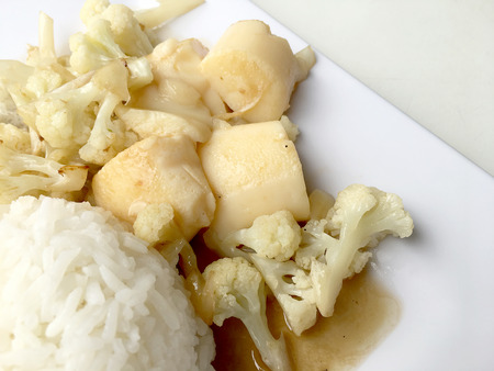 Stir Fried Tofu in Chinese Style,Deep Fried Tofu with Gravy Sauce ,Stir fried tofu with cauliflower and thai style fried egg in white plate on white background. Vegetarian Food, healthy food.の写真素材