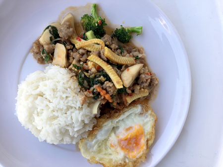 stir fried minced pork with basil eating with rice and fried egg on white background. Thai Food.の写真素材