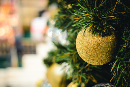 Golden & Silver color of christmas ball on the branches fir with beautiful light bokeh, Decorated Christmas tree. New Year Decoration festive background with vintage tone and selective focus. copy space.の写真素材