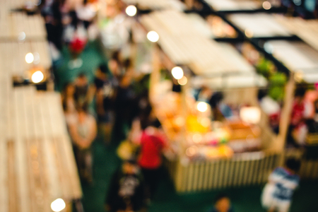 abstract blur image of people go to shopping in night market festival for background usage, vintage tone, top view or bird eye view composition.の写真素材