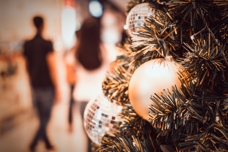 blurred image of Christmas Decorations In Christmas Tree with copy space of blur light boken and people background. vintage toneの写真素材