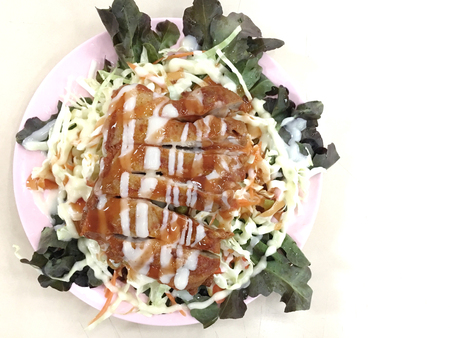 Caesar Salad with grilled chicken on plate with background in the cafeteria.の写真素材