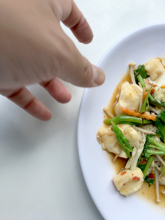 Stir vegetables with Tofu in chinese style with gravy Sauce and thai style omelet with rice in white plate on background. Vegetarian Food, healthy food.の写真素材