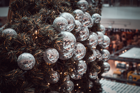 blurred image of Christmas Decorations In Christmas Tree with copy space of blur light boken and people background. vintage toneの写真素材