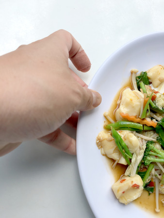 Stir vegetables with Tofu in chinese style with gravy Sauce and thai style omelet with rice in white plate on background. Vegetarian Food, healthy food.の写真素材