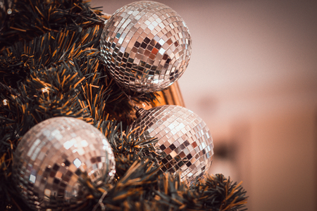 Close up shot of Christmas Decorations In Christmas Tree with copy space of blur light boken and people background. vintage tone.の写真素材