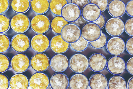 Thai sweets of coconut milk Custard (called "Khanom Thuai") in small porcelain cup at street food market. Traditional Thai dessert. group of Homemade kind of Thai sweetmeat. top viewの写真素材