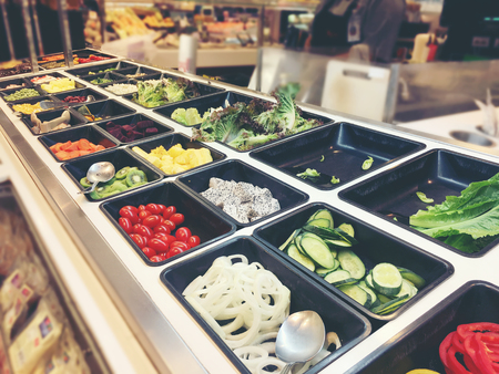 fresh salad bar with various fresh assortment of ingredients, fruits and proteins  Variety of vegetable set for display space of the options for the choice of clients in the supermarket or  restaurantの写真素材