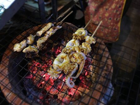 Delicious Grilled squid at street food night market in Bangkok Thailand.の写真素材