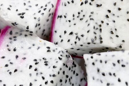 Healthy dragon fruit or pitaya pieces background, close up of beautiful fresh sliced dragon fruit with texture in the market in thailand. Pitaya is the plant in Cactaceae family or Cactus.の写真素材