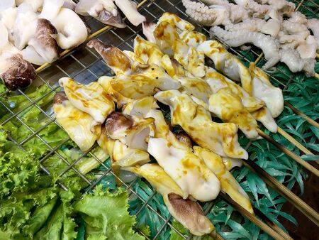 Delicious Grilled squid at street food night market in Bangkok Thailand.の写真素材