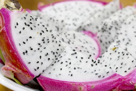 Healthy dragon fruit or pitaya pieces background, close up of beautiful fresh sliced dragon fruit with texture in the market in thailand. Pitaya is the plant in Cactaceae family or Cactus.の写真素材