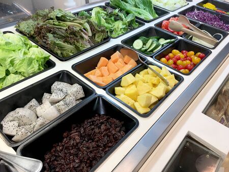 Fresh salad bar with various fresh assortment of ingredients, fruits and proteins Variety of vegetable set for display space of the options for the choice of clients in the supermarket. Take yourselfの写真素材