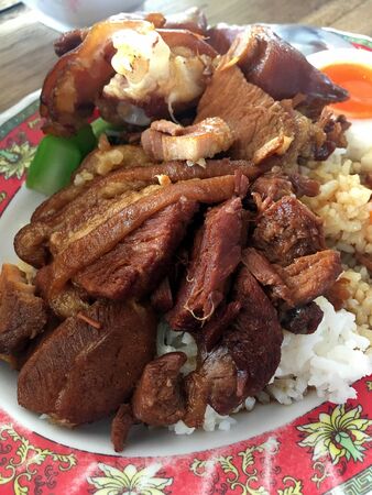 Rice with pork legs with boiled egg and sweet gravy sauce style chinese food in dish on the table, Thai food.Famous food in Thailandの写真素材