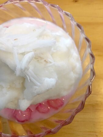 Crispy ruby for coconut milk, Mock Pomegranate in Coconut Syrup with ice cream in small blow on wooden table.Thai dessert Crispy Ruby in Market,Thai desserts is called "Tab Tim Grob"の写真素材