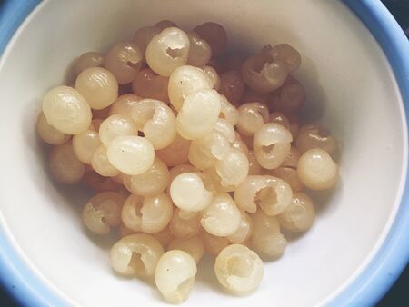 Fresh Longan, Dimocarpus longan meat was removed from longan bark in a white blow, Thai fruit. cooking concept.の写真素材
