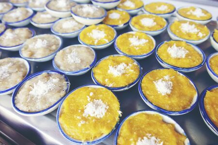 Thai sweets of coconut milk Custard (called "Khanom Thuai") in small porcelain cup at street food market. Traditional Thai dessert. group of Homemade kind of Thai sweetmeat. top viewの写真素材