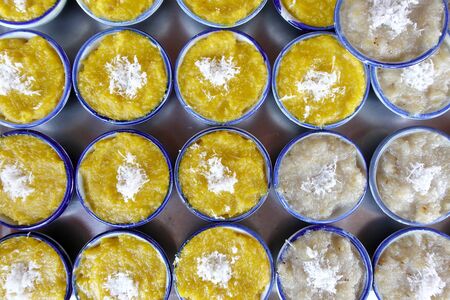 Thai sweets of coconut milk Custard (called "Khanom Thuai") in small porcelain cup at street food market. Traditional Thai dessert. group of Homemade kind of Thai sweetmeat. top viewの写真素材