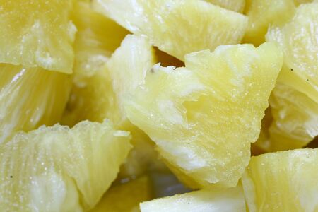 Close up slice pineapple background texture in white dish. Slide and piece of fresh fruit.の写真素材