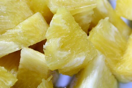 Close up slice pineapple background texture in white dish. Slide and piece of fresh fruit.の写真素材