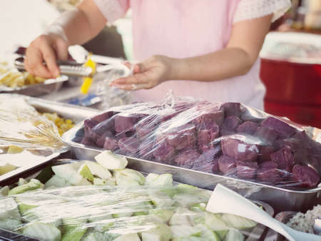 Durian fruit is placed in a red basket for sale to the buyer in fruit market,Thailand. Durian that...