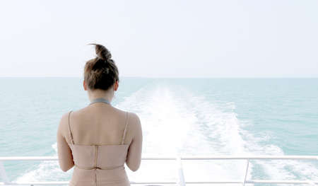 Backside sexy asia woman standing backside high speed ferries in summer for take a photo .Beautiful girl looking blue sea vacation in Trat area: Koh Mak, Koh Kood, Thailand.copy spaceの写真素材