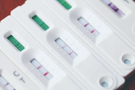 Antigen Test kit with Positive result during swab COVID-19 testing. Coronavirus Self nasal or Home test, Lockdown and Home Isolation concept.の写真素材