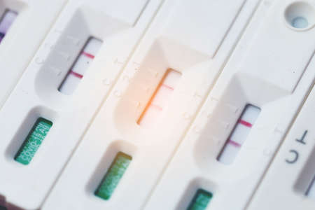 Antigen Test kit with Positive result during swab COVID-19 testing. Coronavirus Self nasal or Home test, Lockdown and Home Isolation concept.の写真素材