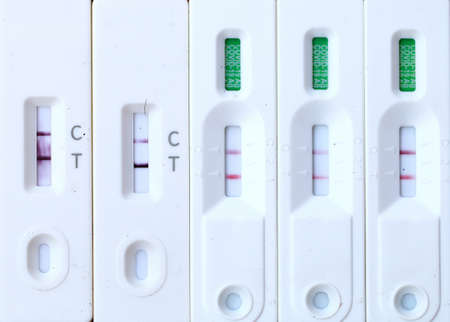 Antigen Test kit with Positive result during swab COVID-19 testing. Coronavirus Self nasal or Home test, Lockdown and Home Isolation concept.の写真素材