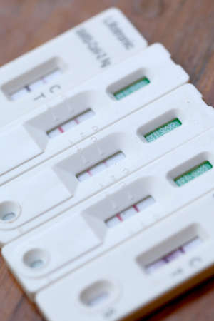 Antigen Test kit with Positive result during swab COVID-19 testing. Coronavirus Self nasal or Home test, Lockdown and Home Isolation concept.の写真素材