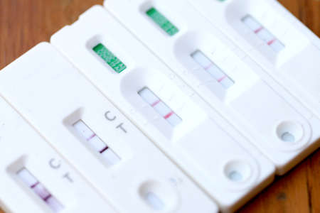 Antigen Test kit with Positive result during swab COVID-19 testing. Coronavirus Self nasal or Home test, Lockdown and Home Isolation concept.の写真素材