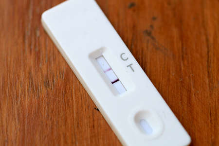 Antigen Test kit with Positive result during swab COVID-19 testing. Coronavirus Self nasal or Home test, Lockdown and Home Isolation concept.の写真素材