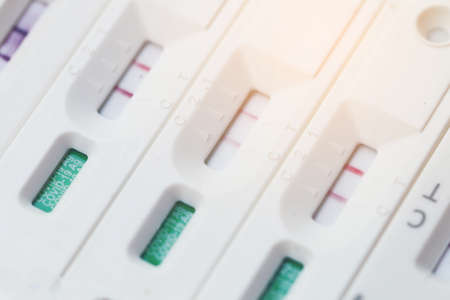 Antigen Test kit with Positive result during swab COVID-19 testing. Coronavirus Self nasal or Home test, Lockdown and Home Isolation concept.の写真素材