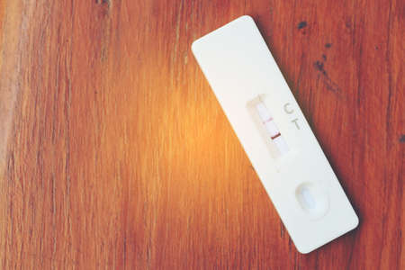 Antigen Test kit with Positive result during swab COVID-19 testing. Coronavirus Self nasal or Home test, Lockdown and Home Isolation concept.の写真素材