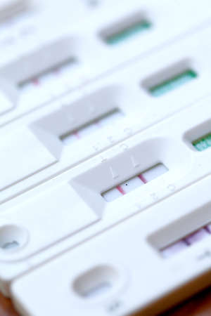 Antigen Test kit with Positive result during swab COVID-19 testing. Coronavirus Self nasal or Home test, Lockdown and Home Isolation concept.の写真素材