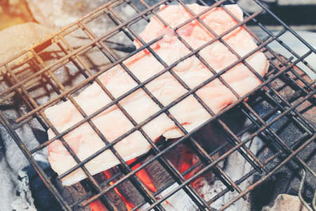 Barbecue pork Toast grill or Pork steak toasted for cooking. Thai food, Street food.Pork satay grilling on stove or Thai style roasted pork at the market.の写真素材