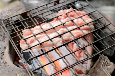 Barbecue pork Toast grill or Pork steak toasted for cooking. Thai food, Street food.Pork satay grilling on stove or Thai style roasted pork at the market.の写真素材
