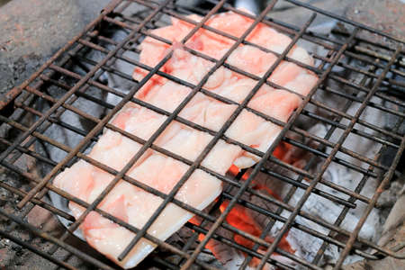 Barbecue pork Toast grill or Pork steak toasted for cooking. Thai food, Street food.Pork satay grilling on stove or Thai style roasted pork at the market.の写真素材