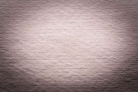 Texture of old shabby and crumpled cover gray paper area with a darkened border, vintage style, abstract close-up backgroundの写真素材