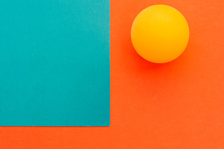 One yellow tennis ball on a red blue backgroundの写真素材