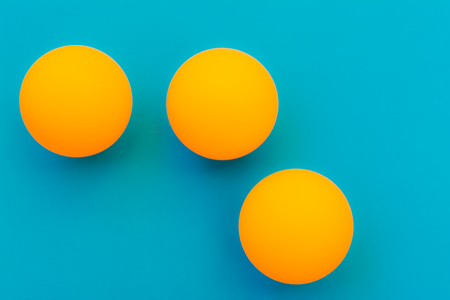 three yellow tennis balls on a blue backgroundの写真素材