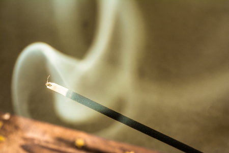 Burning incense sticks and smoke on dark backgroundの写真素材