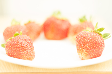 Red fresh strawberries were placed on a white plate, Selective focusの写真素材