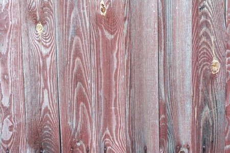 Dark texture of old natural wood with cracks from exposure to sun and wind, abstract backgroundの写真素材