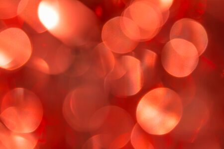 red blurred sparkling festive abstract background based on Christmas ballsの写真素材