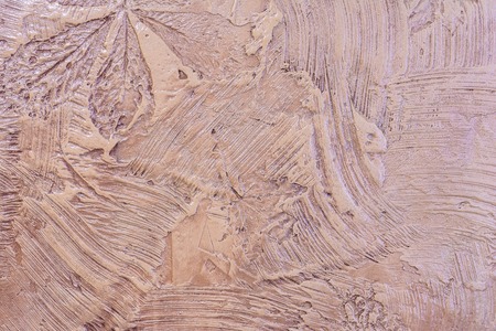 Brown Art Wall Texture, relief decorative plaster with an imprint of various plantsの写真素材
