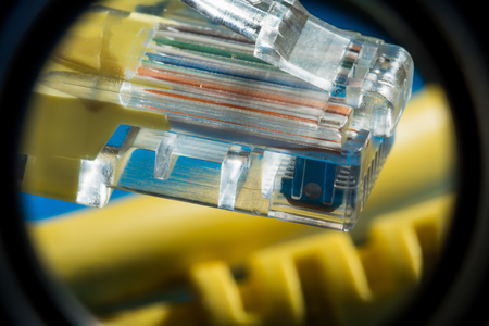 plastic connector RJ45 and yellow cable UTP type twisted pair for connection to a computer network,...