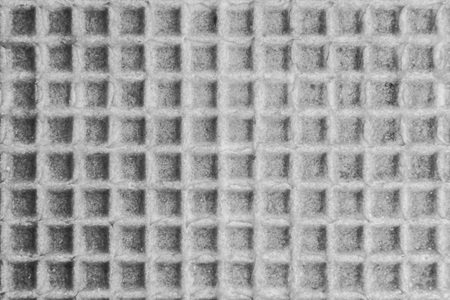 Relief texture of the surface of a cookie or favi, close-up abstract backgroundの写真素材