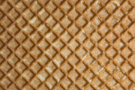 Relief texture of the surface of a cookie or favi, close-up abstract backgroundの写真素材